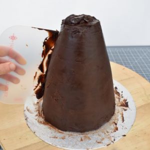 Coat the cake with ganache. Flexi smoothers are great for spreading ganache on odd shapes. Refrigerate until firm.