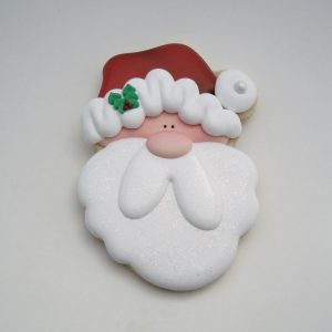 Remove the nose and holly transfers from the wax paper. Using the #12 Wilton tip and the
