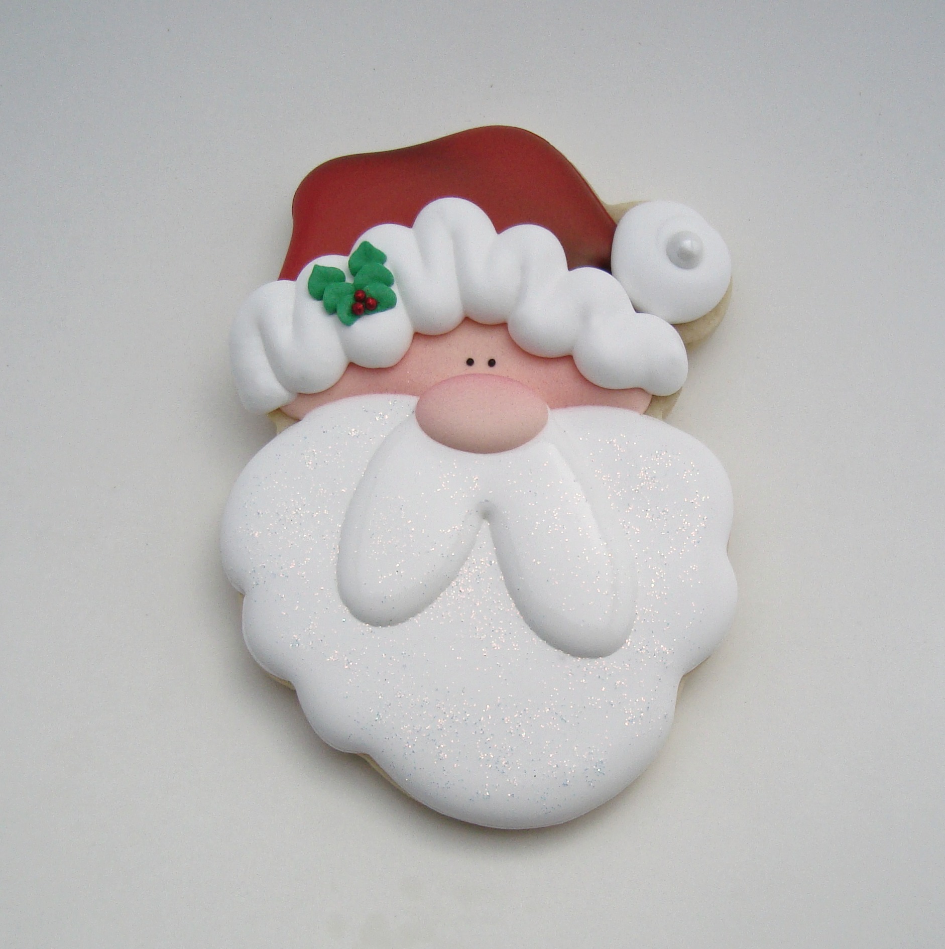 Remove the nose and holly transfers from the wax paper. Using the #12 Wilton tip and the