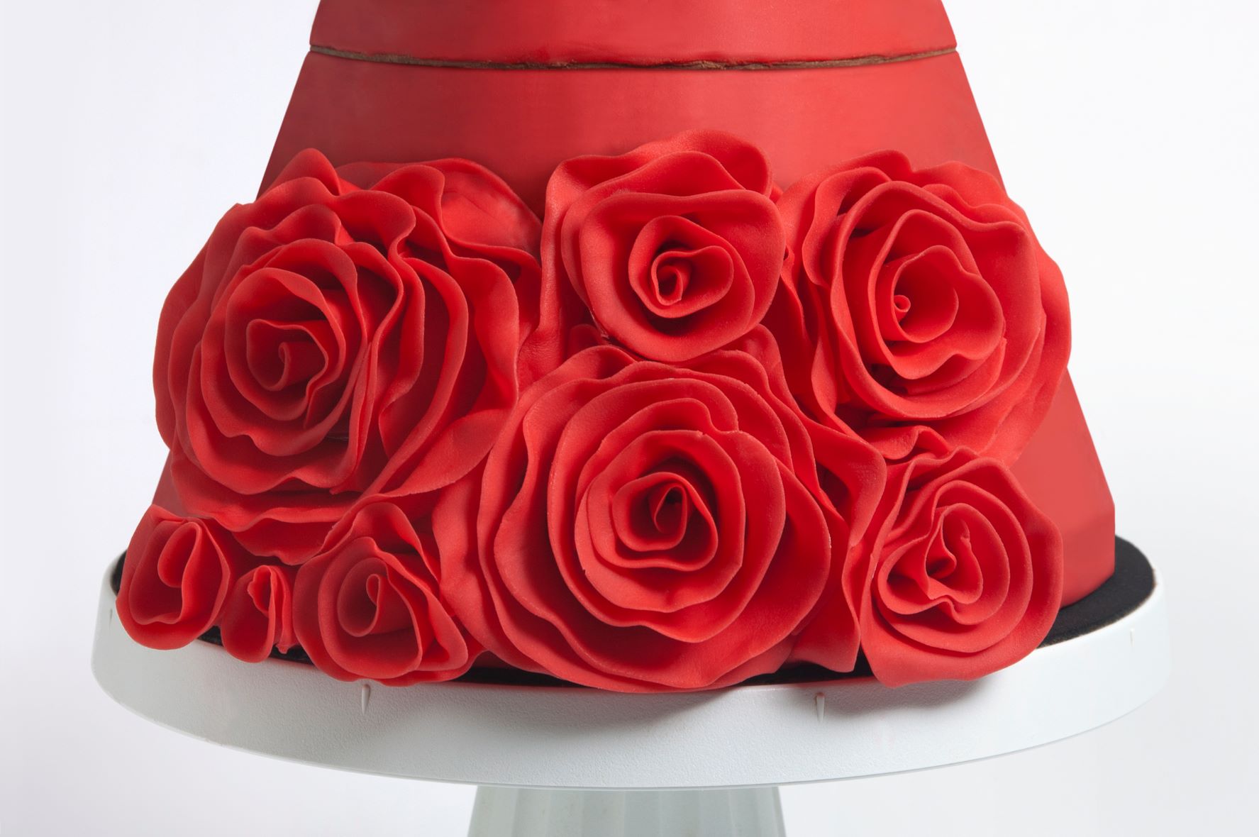 Make more roses of different sizes to fill the empty spaces. Make sure you build up from the base of the cake so the roses can rest on each other slightly.
